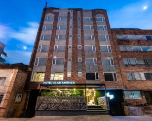 a building with a sign that reads hotel water market at Hotel Vilar América in Bogotá