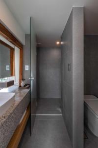 a bathroom with a shower and a toilet and a sink at Luxury hanok with private bathtub - SN16 in Seoul
