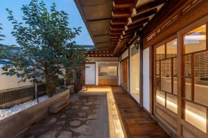an empty corridor of a house with a tree on it at Luxury hanok with private bathtub - SN16 in Seoul