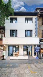 a white building with a lot of windows at Gongxili - Chujian Hotel in Kunming