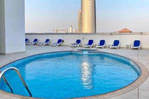 a swimming pool on the roof of a building at Maison Privee - Lovely Apt with Lake Walkways Close to JBR Beach in Dubai