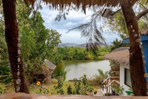 a view from the porch of a house with a lake at Azul Zambales Beachfront House & River Cottages EXCLUSIVE in Cabangan