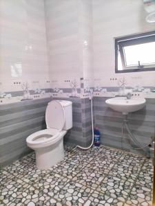 a bathroom with a toilet and a sink at Chất home in Da Lat