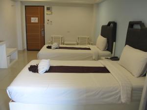 a hotel room with two beds in a room at Sunny Residence in Lat Krabang