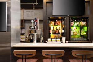 a bar with a lot of bottles of alcohol at Courtyard by Marriott Washington Capitol Hill/Navy Yard in Washington