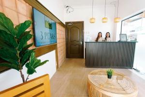 two women standing at a counter in a room at 3 Peaks Resort & Boutique Hotel in Lipa