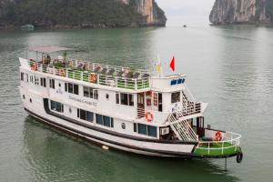 a ferry boat in the water near a mountain at Fantasea Imperial Cruise in Ha Long