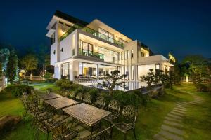 a large house with a table and chairs in front of it at Fantasea Imperial Cruise in Ha Long