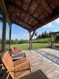 two chairs sitting on a porch with a roof at Casa din Deal-Cincu in Cincu