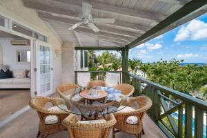 a patio with a table and chairs on a balcony at Beacon Hill 305 - The Penthouse in Saint Peter