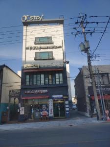 a building with a sign on the side of it at T stay pension in Cheongju