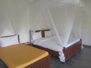 Postel nebo postele na pokoji v ubytování Chamodya Home Stay