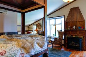 a bedroom with a large bed and a fireplace at Stone Chalet Bed & Breakfast Inn in Ann Arbor +79 photos
