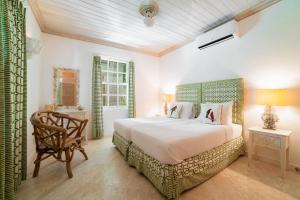 a bedroom with a large bed and a chair at Beacon Hill 202 - Moonshadow by Blue Sky Luxury in Saint Peter