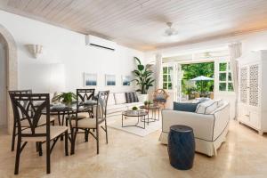 a living room with a couch and a table and chairs at Beacon Hill 202 - Moonshadow by Blue Sky Luxury in Saint Peter +4 photos