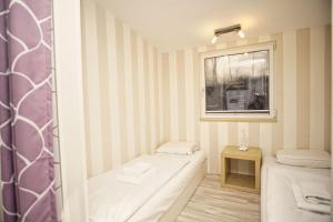 a small room with two beds and a window at Dünenchalet Nr 49 in Göhren