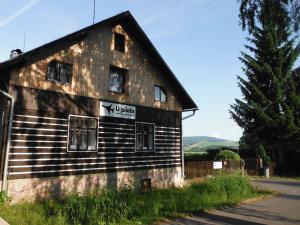 an old building with a sign on the side of it at Chalupa U Pilota in Králíky