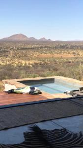 a swimming pool in the middle of the desert at LEOPARD'S VIEW MOUNTAIN VILLA @ Steinheim Game Farm & Camping in Prospect