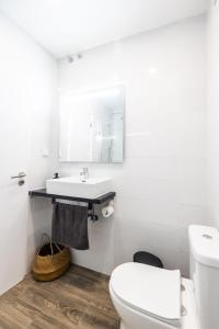 a bathroom with a white toilet and a sink at Holy Escape in Santa Cruz +15 photos