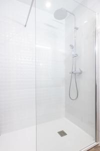 a bathroom with a shower with a glass door at Holy Escape in Santa Cruz