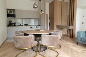 a kitchen and dining room with a table and chairs at Luxury Apartment Villa Ortler in Merano