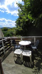 einen weißen Tisch und Stühle auf einer Terrasse mit Tisch und Stühlen in der Unterkunft Perix House in Neos Marmaras