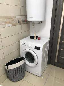 a washer and dryer with a tank on top of it at CaSa Stai in Mangalia