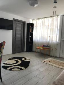 a living room with a door and a rug at CaSa Stai in Mangalia