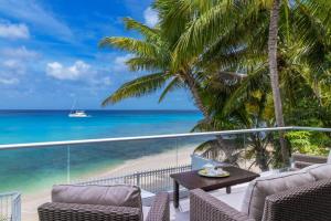 einen Balkon mit Meerblick und einem Boot in der Unterkunft Westshore Beach House by Blue Sky Luxury in Saint James