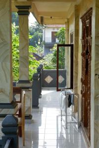 a hallway leading to a door in a building at Kenari House in Ubud