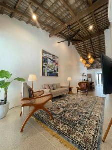 a living room with a couch and a rug at Arau House in Arau