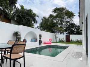 a pool with chairs and a table next to a fence at Arau House in Arau