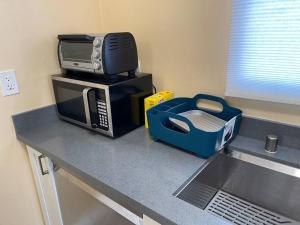 a microwave sitting on top of a kitchen counter at Warm 2BR/1BA house Silicon W/D parkin near SJ town in San Jose