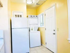 a kitchen with a white refrigerator and a white door at Warm 2BR/1BA house Silicon W/D parkin near SJ town in San Jose