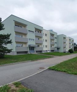 a row of apartment buildings on a street at Pae külaliskorter in Kärdla