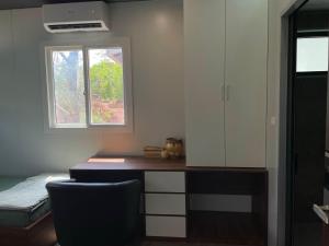 a room with a desk and a window at Halo Retreat in Hòa Bình