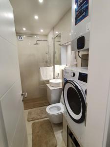 a bathroom with a toilet and a washing machine at Heart of Sarajevo - Baščaršija Private Garage in Sarajevo +26 photos
