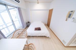a small room with a bed and two chairs at Takadanobaba Address102 in Tokyo +25 photos