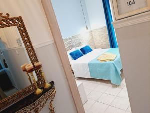 a view of a bedroom with a bed and a mirror at Hotel Kastro in Skiathos Town
