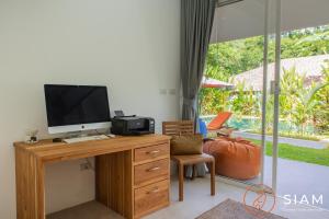 a room with a desk with a computer on it at Villa Sumalee 3Br Private Pool in Koh Samui 