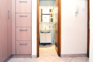 Cute and Cosy apartment في زغرب: حمام مع حوض ومرحاض وباب