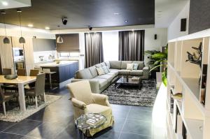 a living room with a couch and a table at Paramount Bay Penthouse in Birżebbuġa