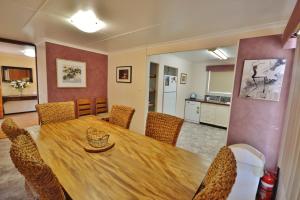 a dining room with a wooden table and chairs at Aquarius - Kalbarri, WA in Kalbarri