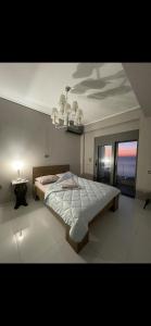 a bedroom with a large bed and a table at Luxury Apartment Sea View Chalkida in Chalkida +69 photos