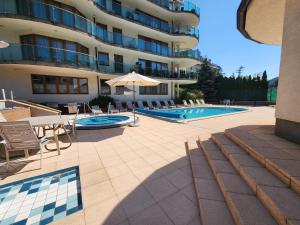 a hotel with a swimming pool and a building at Kristoff Plaza Trencianske Teplice in Trenčín