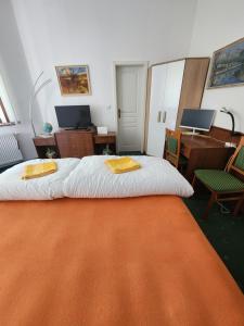 a bedroom with a bed with two towels on it at Kristoff Plaza Trencianske Teplice in Trenčín