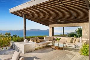 a patio with a couch and a table at Villa Raku in Koh Samui