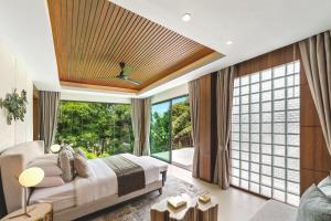 a bedroom with a bed and a large window at Villa Raku in Koh Samui  +57 photos