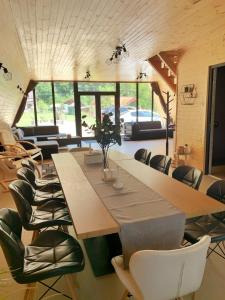 a dining room with a large wooden table and chairs at Cabana A Vaideeni in Vaideeni