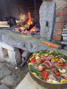 a pan of food in front of a brick oven at Apartments Bosket in Kastav +32 photos